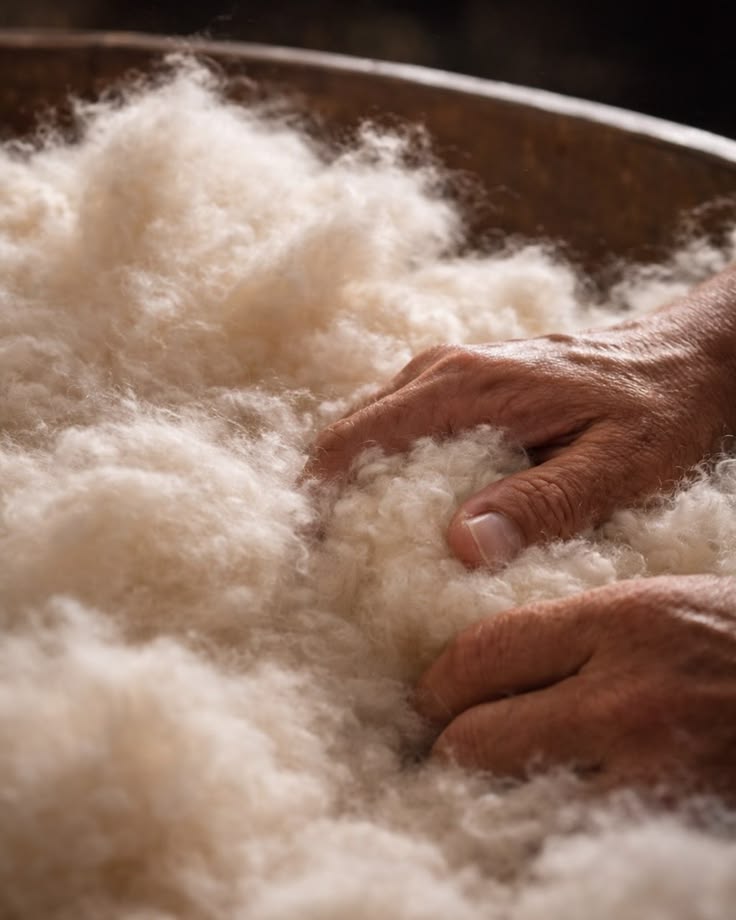 Artisan hands working with premium goose down